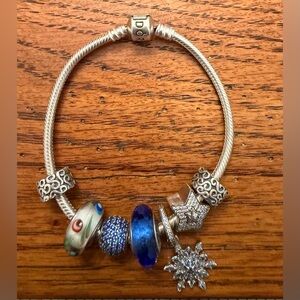 Pandora bracelet with 5 charms and 2 stopper clips on each side of charms